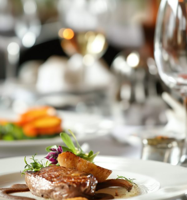Experience luxurious dining with gourmet meal served elegantly in upscale restaurant setting, enhanced by fine ambiance and exquisite presentation